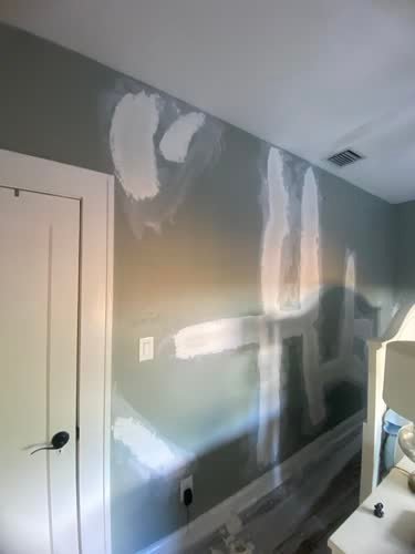 Drywall patches on a bedroom wall