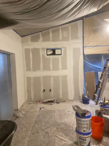 Room with new drywall taped and mudded